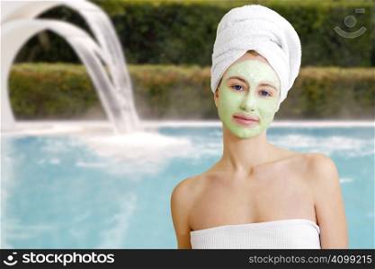 Young woman with facial mask in beauty spa.