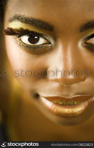 Young Woman with False Eyelashes and Gold Lipstick