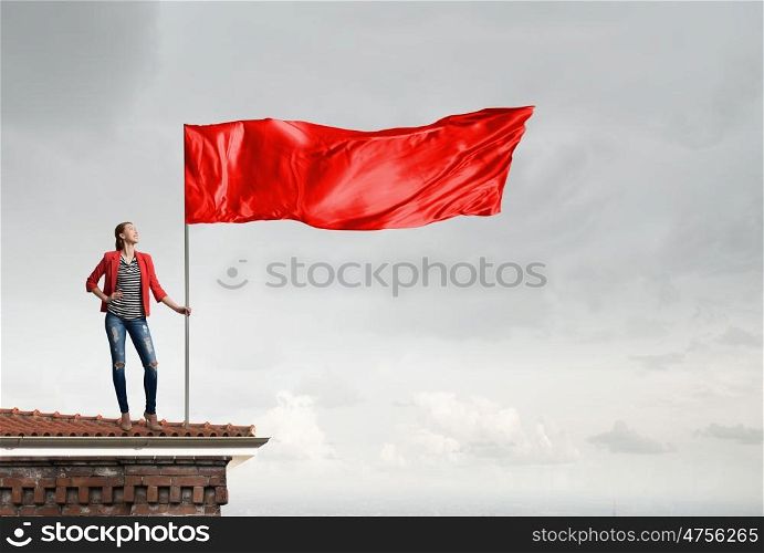 Young woman with flag. Young woman in red jacket holding waving flag