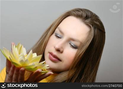 young woman with flower in hands