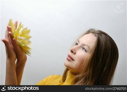 young woman with flower in hands