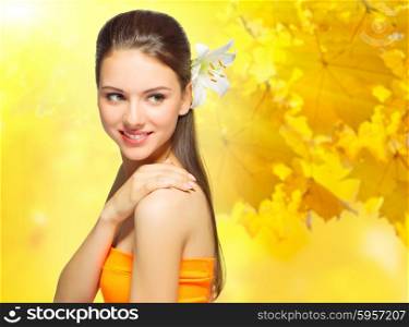 Young woman with flower on autumnal background
