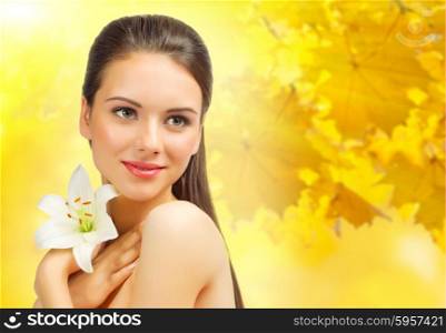 Young woman with flower on autumnal background