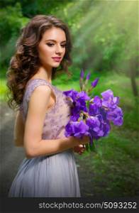 Young woman with flowers in the forest (with sunrays ver)