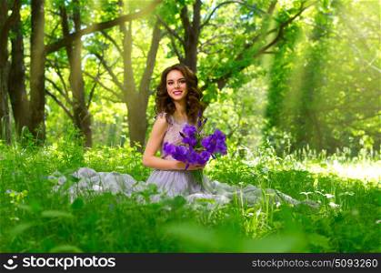 Young woman with flowers in the forest (with sunrays ver)