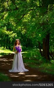 Young woman with flowers in the forest (without sunrays ver)