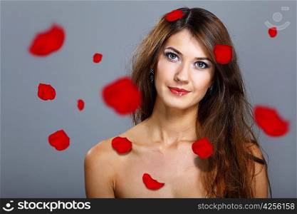 Young woman with flowers on background