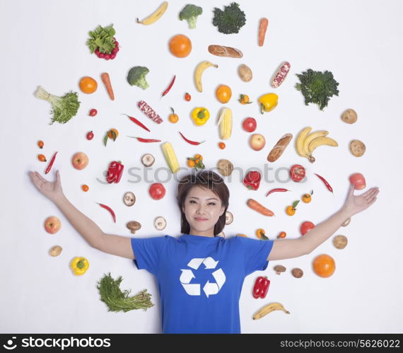 Young woman with fresh fruit and vegetables, studio shot