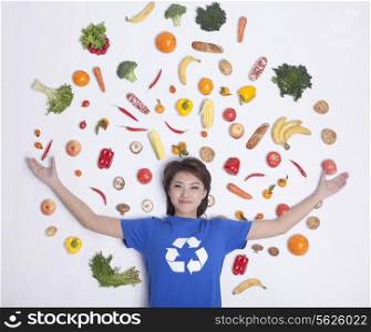 Young woman with fresh fruit and vegetables, studio shot