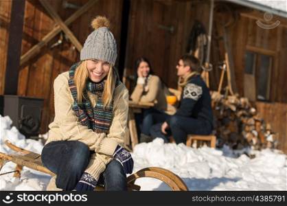 Young woman with friends enjoy weekend break snow winter cottage