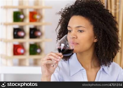 young woman with glass of red wine closeup