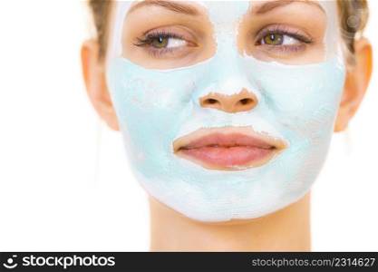 Young woman with green mud mask on face, on white. Teen girl taking care of oily skin, purifying the pores. Beauty treatment. Skincare.. Girl with green mud mask on face