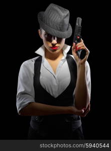 Young woman with gun on black