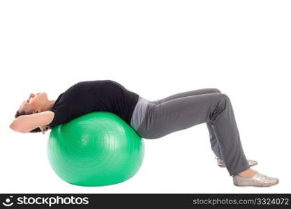 Young woman with gym ball doing situps exercise, isolated on white background.