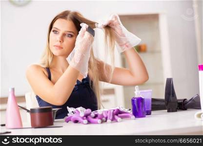 Young woman with hair curlers at barbershop 
