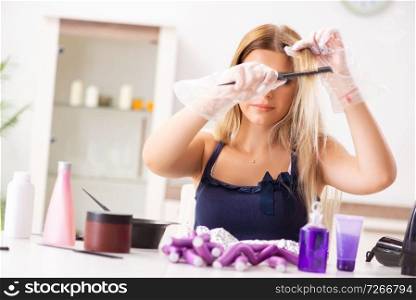 Young woman with hair curlers at barbershop 