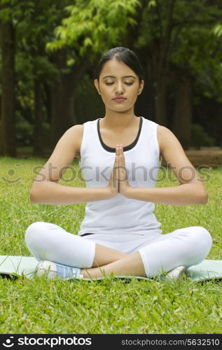 Young woman with hands in prayer position