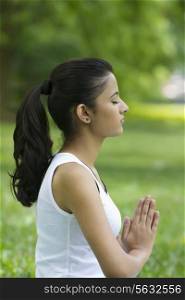 Young woman with hands in prayer position
