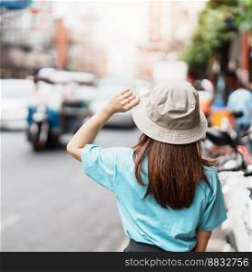 Young Woman with hat traveling in Bangkok, Asian traveler visiting at Yaowarat road or Chinatown of Bangkok, landmark and popular for tourist attractions in Thailand. Southeast Asia Travel concept