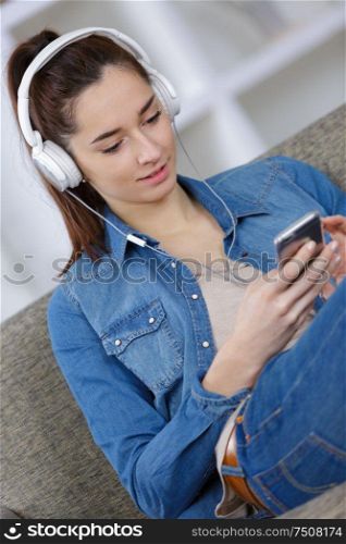 young woman with headphones and phone