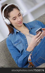 young woman with headphones and phone