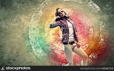 Young woman with headphones. Image of young pretty woman with headphones dancing