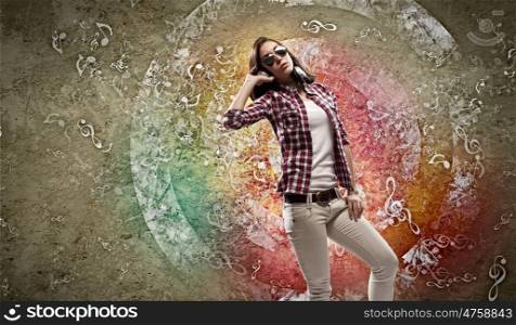 Young woman with headphones. Image of young pretty woman with headphones dancing