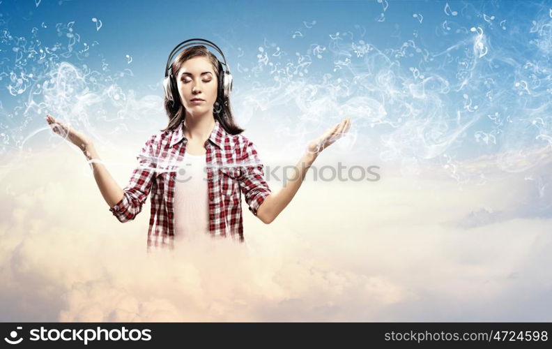 Young woman with headphones. Image of young pretty woman with headphones meditating