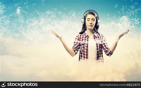 Young woman with headphones. Image of young pretty woman with headphones meditating