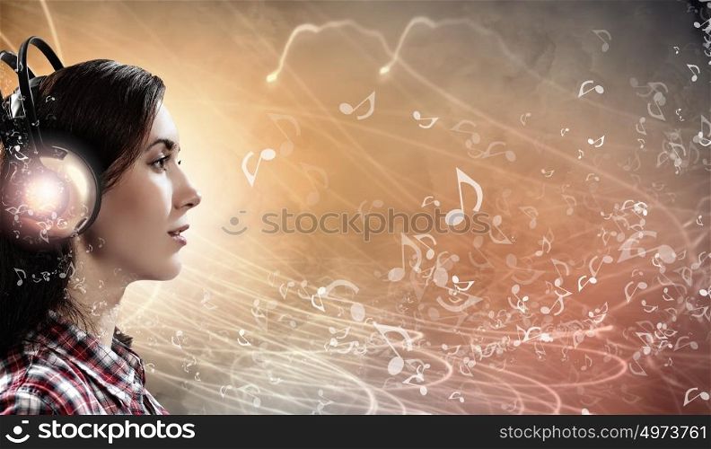 Young woman with headphones. Image of young pretty woman with headphones. Side view