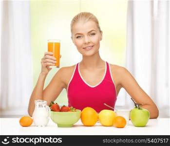 young woman with healthy breakfast and holding orange juice