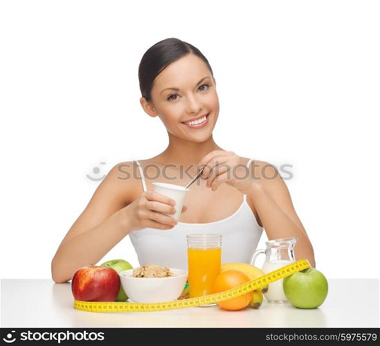 young woman with healthy breakfast and measuring tape. woman with healthy breakfast and measuring tape