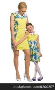 Young woman with her daughter in yellow dresses isolated