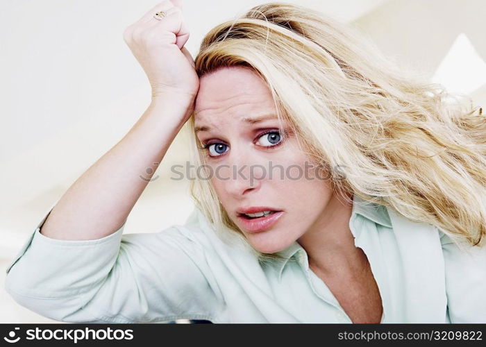 Young woman with her hand on her head