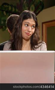 Young Woman with Laptop Shrugging