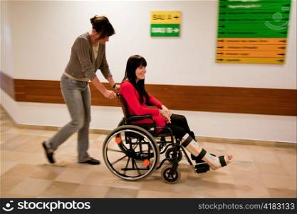 young woman with leg in plaster, and nurse rollsruhl