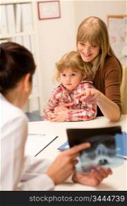 Young woman with little daughter having consultation at pediatrician office