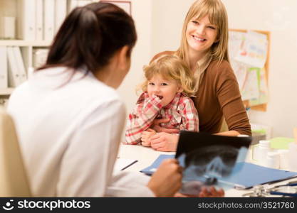 Young woman with little daughter having consultation at pediatrician office