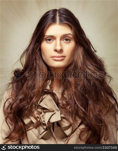 Young woman with long frizzy hair on abstract background