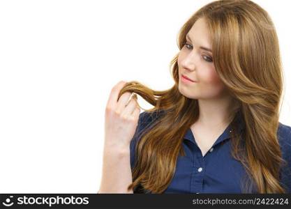 Young woman with long hair shows healthy ends, on white. Woman with long hair shows healthy ends