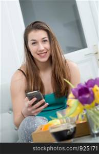 young woman with long hair using a smartphone