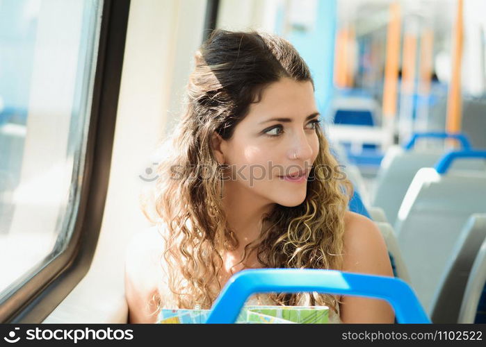 Young woman with map traveling by the train. Enjoying travel concept.