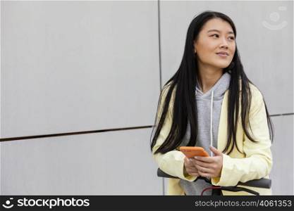 young woman with mobile outdoor