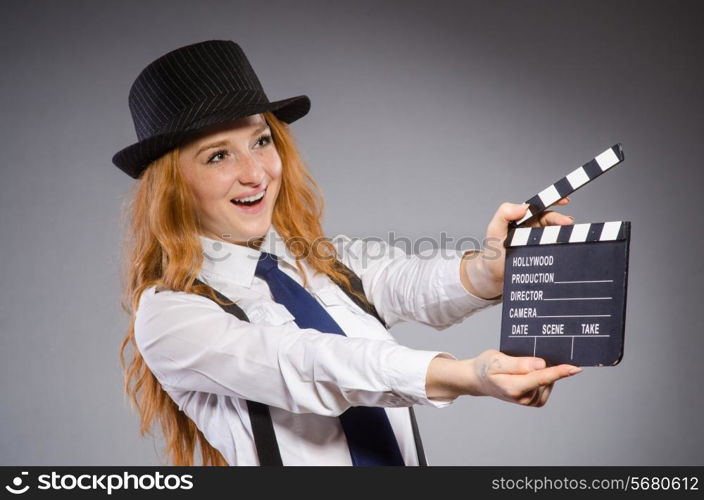 Young woman with movie board