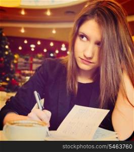 young woman with notebook in modern cafe. young woman with notebook