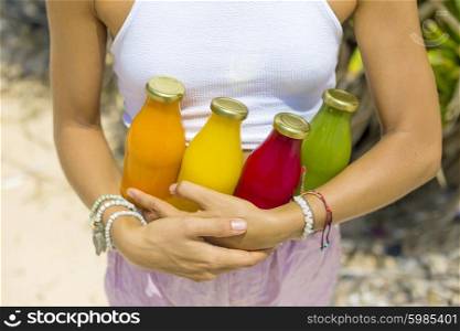 Young woman with Organic cold-pressed raw vegetable juice