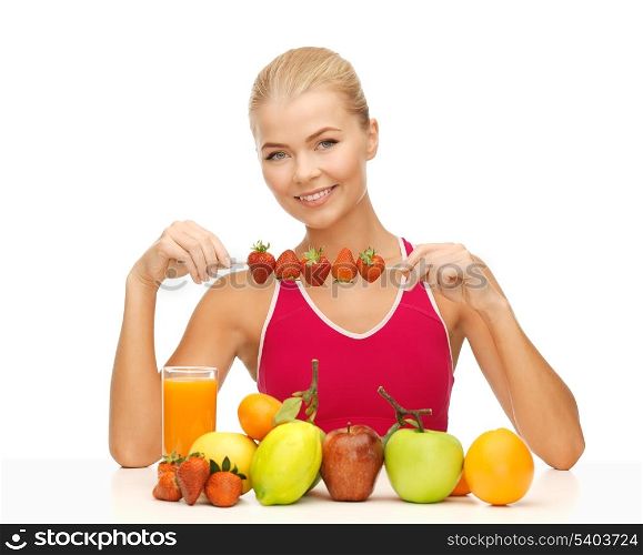 young woman with organic food or fruits eating strawberry
