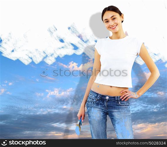 Young woman with paint brush and wall with natural landscape