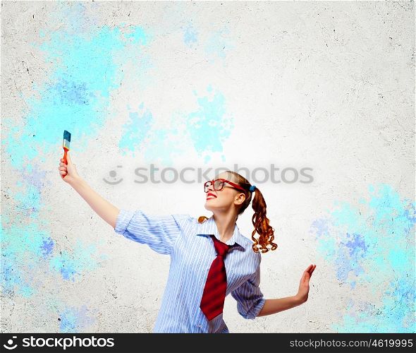 Young woman with paint brush. Image of young woman painter with brush