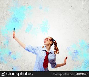 Young woman with paint brush. Image of young woman painter with brush